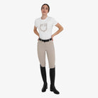 Equestro Women's Hunter Knee Grip Breeches - Beige, worn with tall boots | Malvern Saddlery