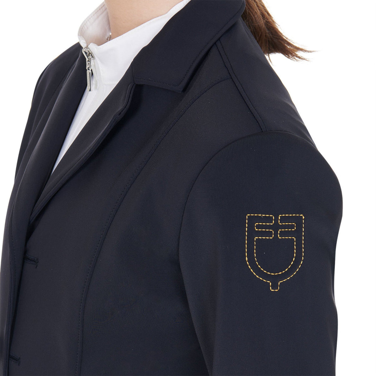 Equestro Girls 4-Button Competition Riding Jacket - Navy; detail left shoulder yellow stitched logo | Children's Show Apparel | Malvern Saddlery