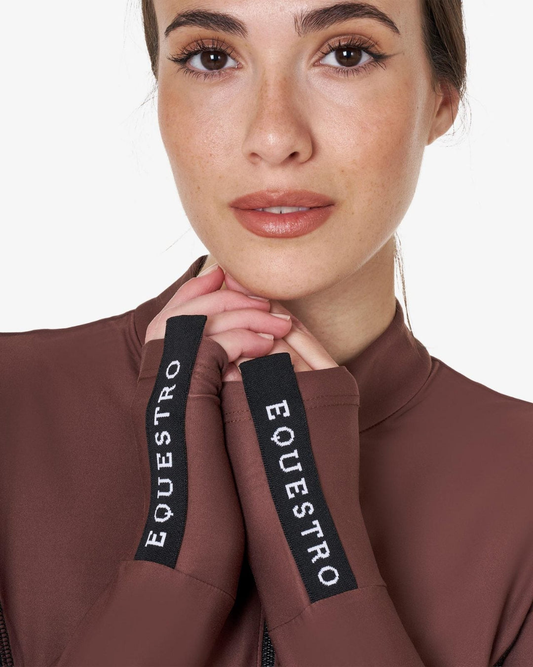 Equestro Women's Long-Sleeved Technical Polo Shirt - Maroon; close up of wrists with equestro tabs on woman on white background | Equestrian Training Shirts | Malvern Saddlery