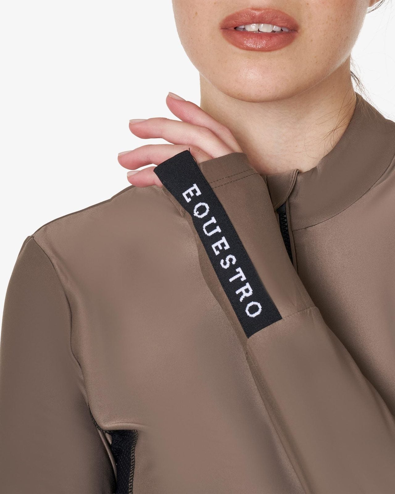 Equestro Women's Long-Sleeved Technical Polo Shirt - Walnut; close up of wrist tab on woman on white background | Equestrian Training Shirts | Malvern Saddlery