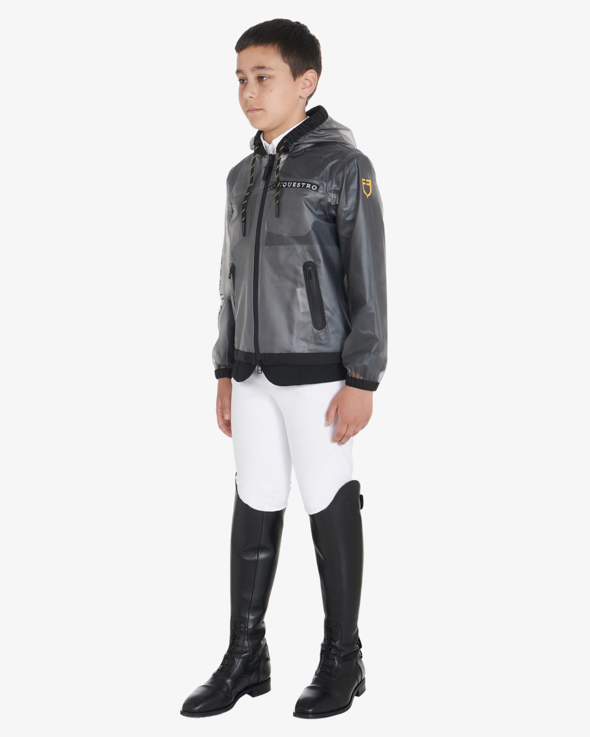 Equestro Young Rider Unisex Raincoat - shown on boy wearing show coat under, white breeches & black riding boots  | Children's Riding Apparel | Malvern Saddlery