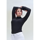 For Horses Willa Women's Long Sleeve Schooling Shirt in Black showing stretch with arms raised