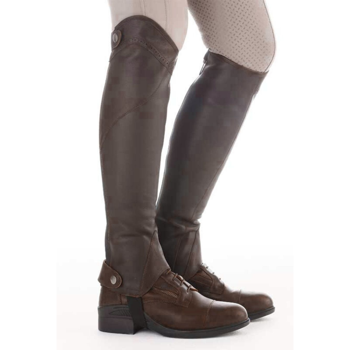 Kavalkade Remus oiled leather half chaps in brown paired with paddock boots, side profile on model | Malvern Saddlery