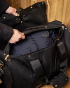 LeMieux Luxe Show Jacket Duffle Bag, person opening duffle compartment with navy jacket inside | Equestrian Travel Accessories | Malvern Saddlery