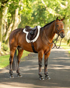 LeMieux Merino+ ProSorb Hunter Pro Saddle Pad - White/White; shown on chestnut horse with full tack on road, blurred background | Malvern Saddlery
