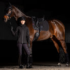 LeMieux ProSorb Plain 2 Pocket Dressage Square Saddle Pad - Black; shown on horse with black saddle, rider standing next to, black background | Tack Shop | Malvern Saddlery