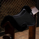 LeMieux Streamline Half Pad - Black/Black; shown on saddle rack with brown lattice wall background  | Equestrian Correction Pads | Malvern Saddlery