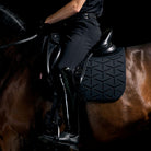 LeMieux ProForm Molded Dressage Saddle Pad - Black; close up shown on horse with saddle & rider, black background  | Malvern Saddlery