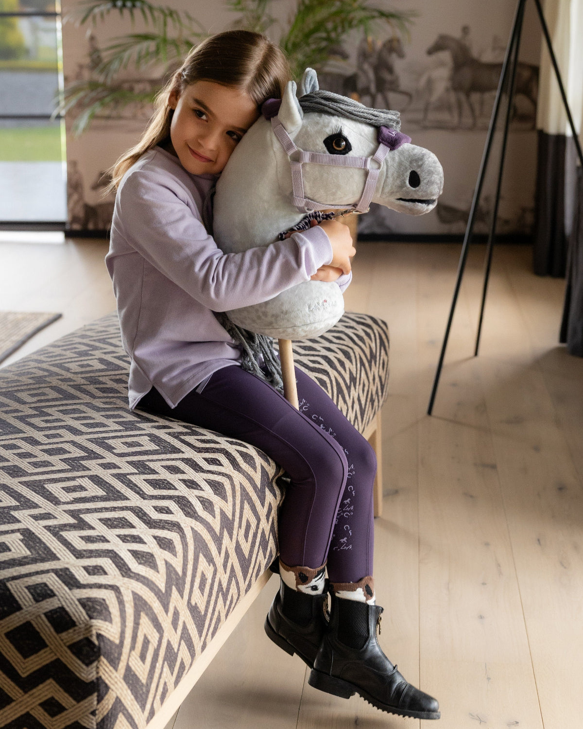 LeMieux Hobby Horse - "Earl" - shown with girl hugging toy | Malvern Saddlery
