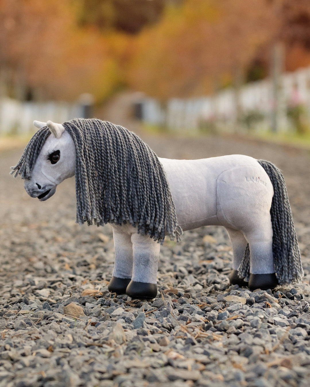 LeMieux Toy Pony - "Blanca", white plush with gray mane, shown on gravel road | Children's Toys | Malvern Saddlery