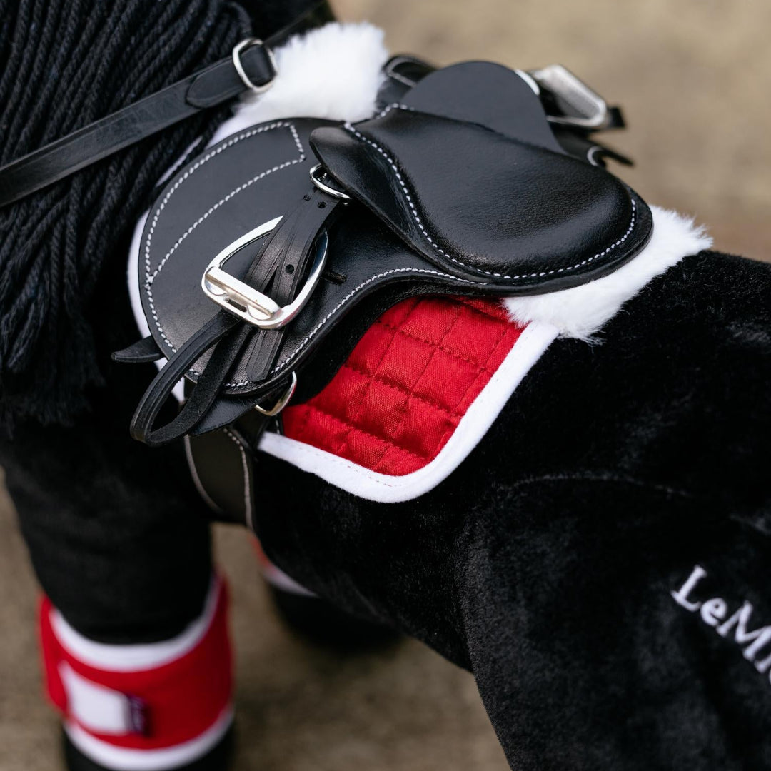 LeMieux Toy Pony Christmas Set of fly hood, saddle pad & polo wraps - red & white; shown on black toy pony with black saddle | Malvern Saddlery