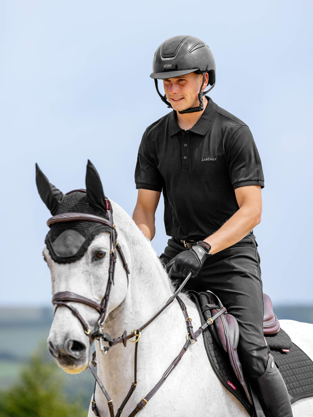 LeMieux Men's Classique Polo Shirt - Black - shown on man on white horse | Men's Athletic Wear | Malvern Saddlery