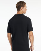 LeMieux Men's Classique Polo Shirt - Black - shown on man on white background - back view| Men's Athletic Wear | Malvern Saddlery