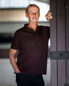 LeMieux Men's Classique Polo Shirt - Damson Red - shown on model with by barn door | Men's Athletic Wear | Malvern Saddlery