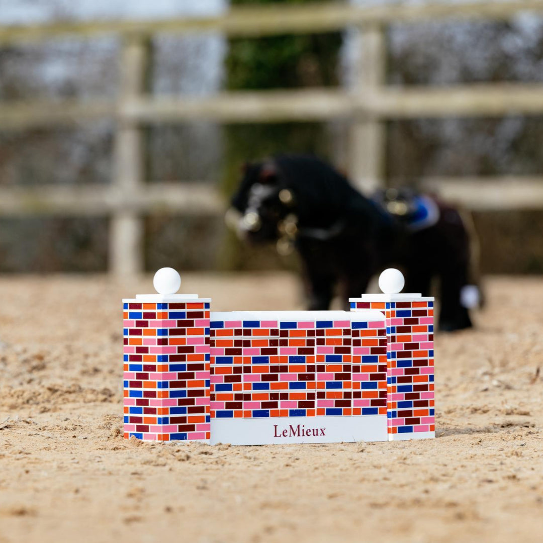 LeMieux Toy Pony Puissance Wall Jump Set; shown outdoor in horse ring with toy pony in background | Malvern Saddlery