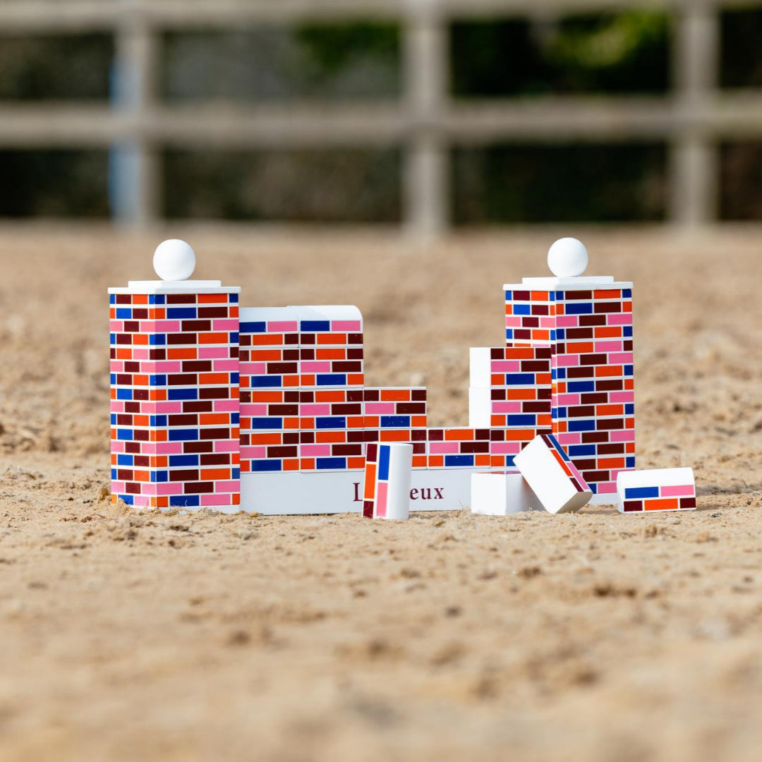 LeMieux Toy Pony Puissance Wall Jump Set; shown outdoor in horse ring with some blocks knocked off | Malvern Saddlery