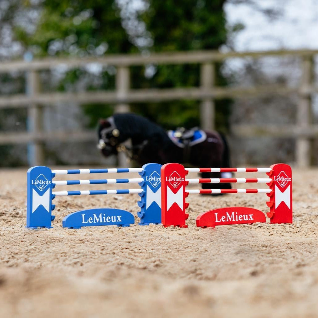 LeMieux Toy Pony Benetton Jump Set - shown outdoors on horse arena with toy pony & trees in background | Malvern Saddlery