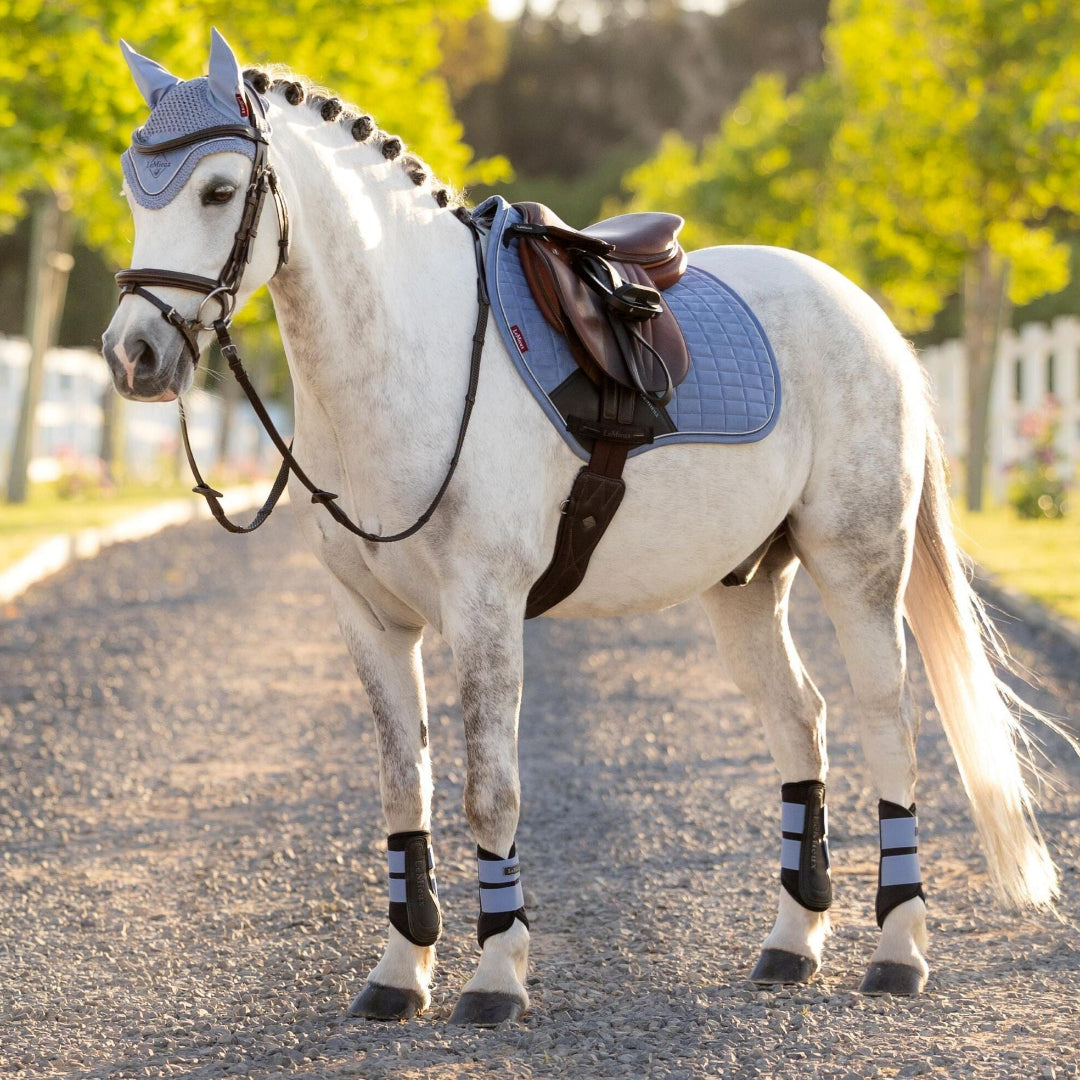 LeMieux Mini Suede Close Contact Square Saddle Pad -Pony - Powder Blue; shown on white pony with tack outdoors |  Malvern Saddlery