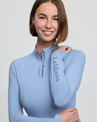 LeMieux Classique Women's Base Layer Top - Powder Blue; close up shown on woman, gray background | Malvern Saddlery