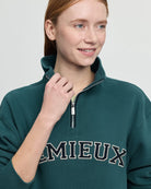 LeMieux Kelsie Quarter Neck Sweatshirt - Jungle Green; close up shown on person against gray background  | Malvern Saddlery