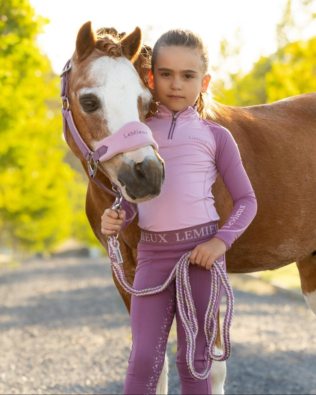 LeMieux Mini Base Layer Top - Fondant Pink; shown on girl with pony outdoors | Malvern Saddlery