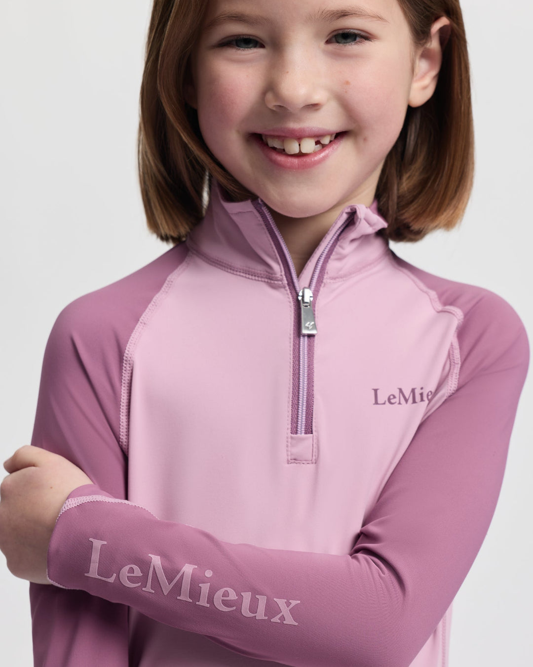 LeMieux Mini Base Layer Top - Fondant Pink; close up shown on girl | Malvern Saddlery