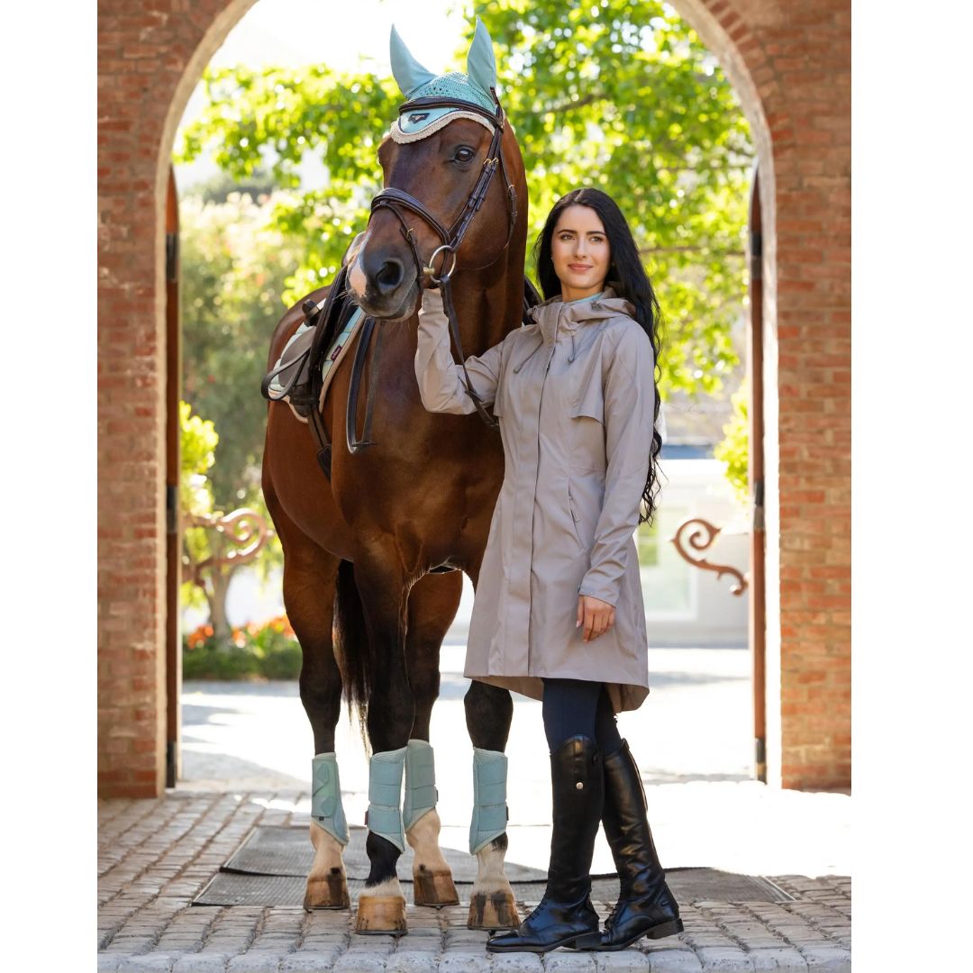 LeMieux Grace Long Rain Jacket - Pecan, shown on model standing with chestnut horse | Malvern Saddlery