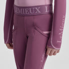 LeMieux Mini Pull On Breech - Mallow Pink; close up of waist & pockets model, gray background | Malvern Saddlery