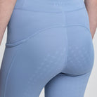LeMieux Young Rider Orla Pull Ons - Powder Blue; shown on model, full seat grip close up | Malvern Saddlery