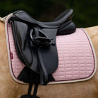 LeMieux Suede Dressage Square Saddle Pad - Blossom Pink, shown on Palomino horse with black saddle detail | Malvern Saddlery