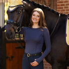 LeMieux Britney Seamless Long Sleeve Top - Dusk Blue, shown on rider standing next to dark brown horse | Malvern Saddlery