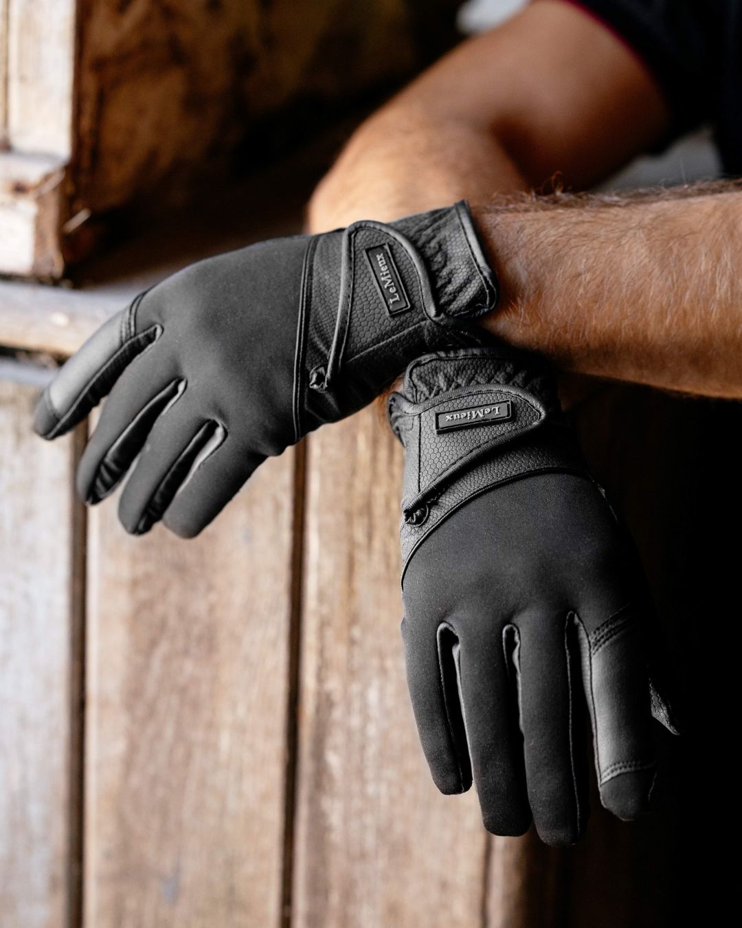 LeMieux Hybrid Riding Gloves - Black, shown on man in barn| Malvern Saddlery