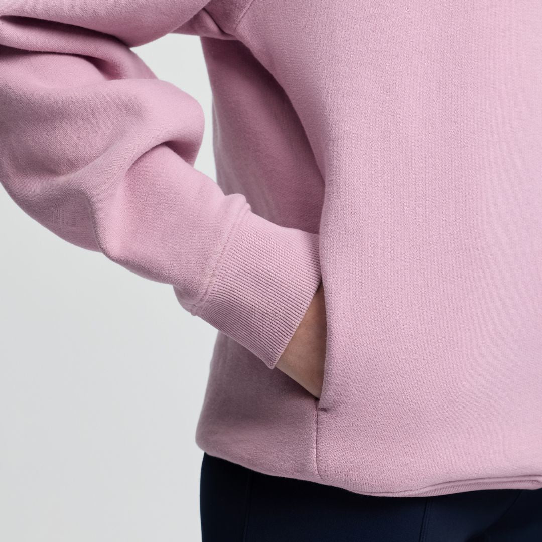 LeMieux Young Rider Sia Hoodie - Fondant PInk; pocket detail shown on person | Malvern Saddlery