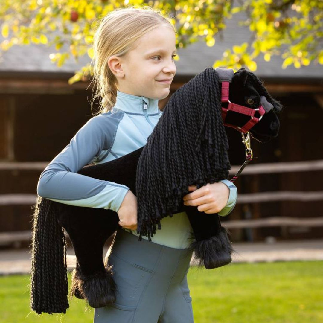 LeMieux Toy Pony- Friesian - "Spike", shown with ember halter (sold separately) held by young girl| Malvern Saddlery