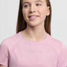 LeMieux Young Rider Sports T-Shirt - Fondant Pink; close up of neck & chest worn by girl on gray background | Malvern Saddlery