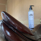 Purvida All-In-One Leather Balm, shown with brown saddle | Malvern Saddlery