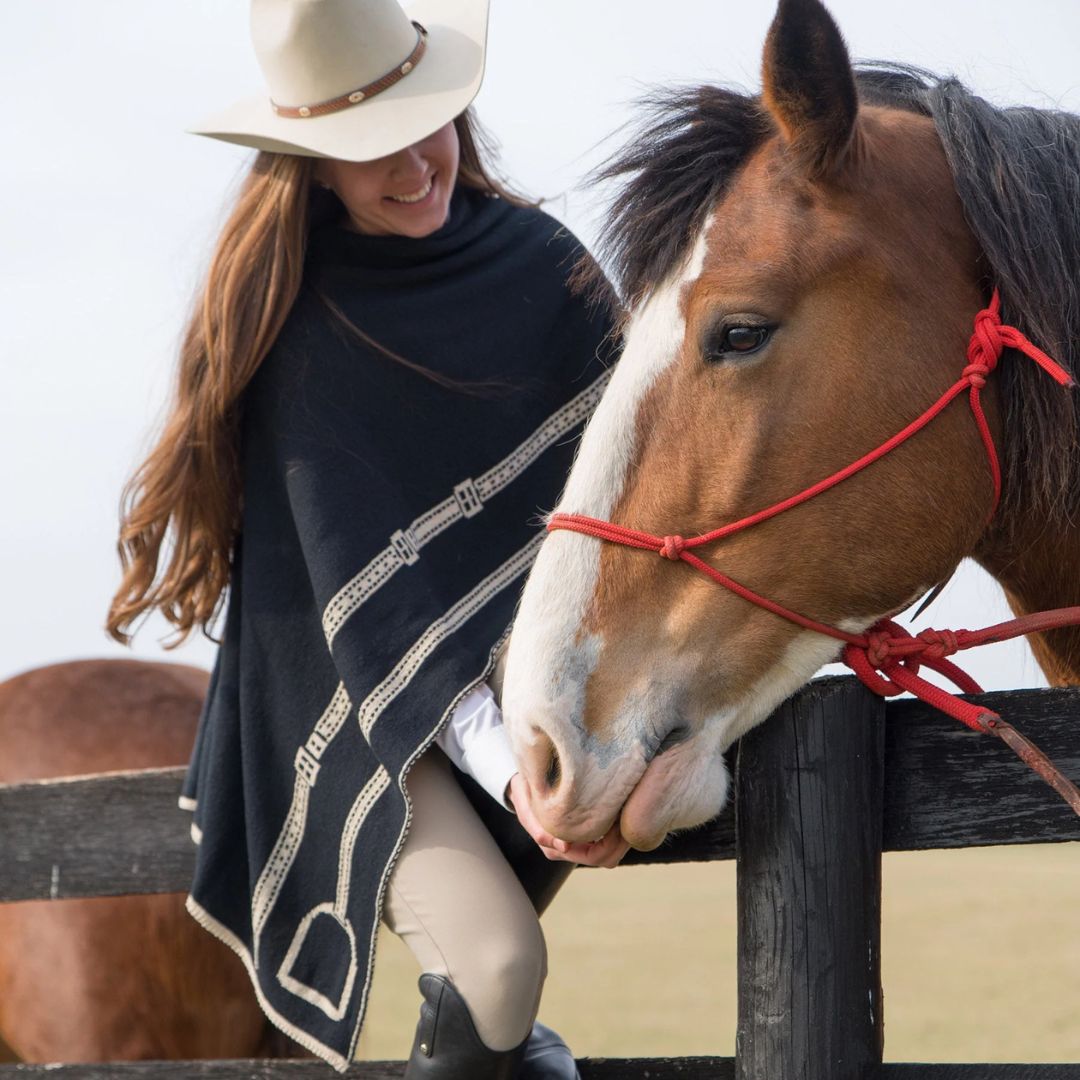 Equestrian Stirrup Poncho - Black & Tan, shown on woman with horse | Malvern Saddlery