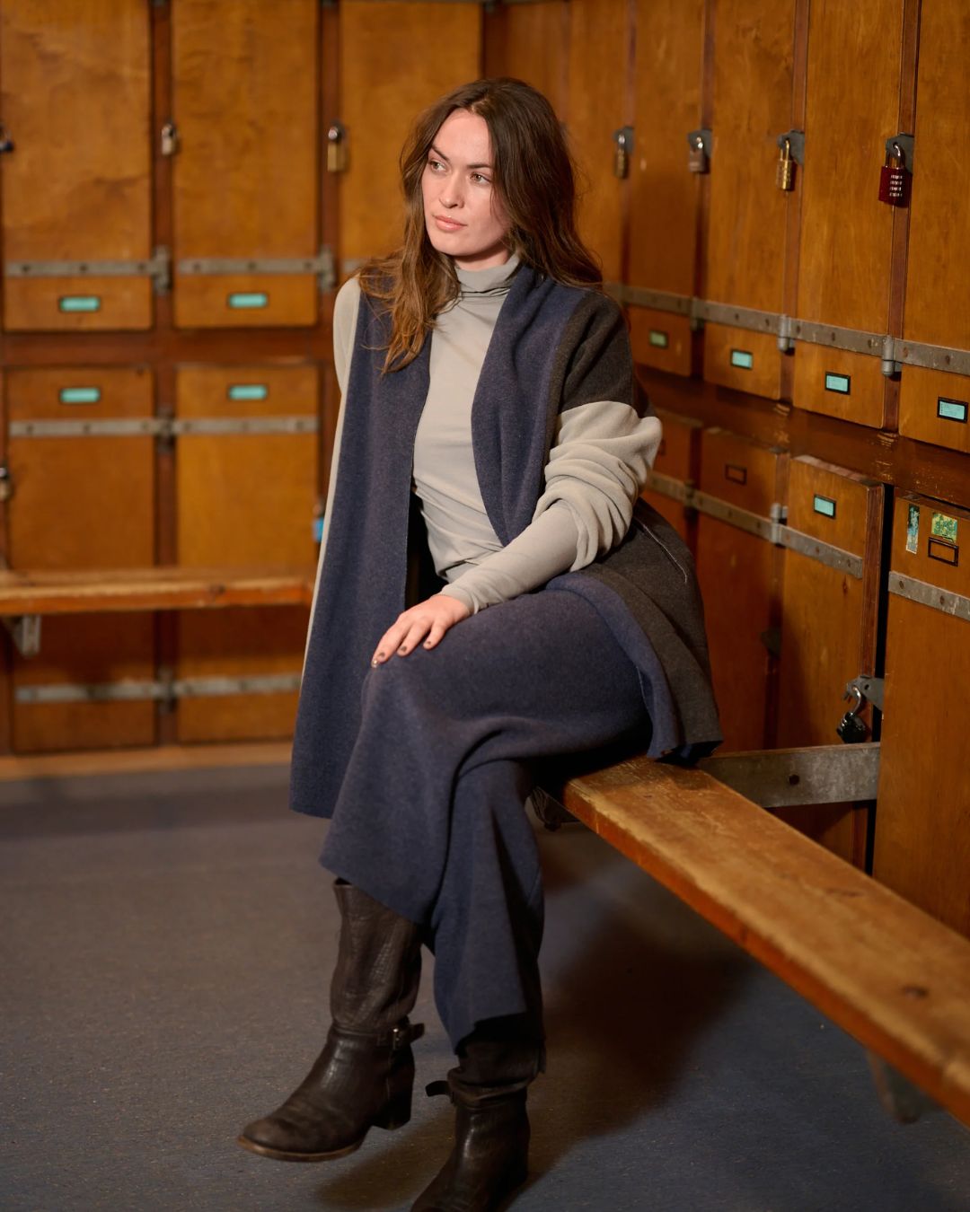 Luxe Fleece Patch Women's Cardigan - Evening Blue/Chocolate/Elephant Gray; worn by woman sitting in locker room | Malvern Saddlery